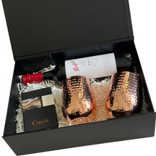 Load image into Gallery viewer, A luxury gift set in an open black box, featuring two hammered copper wine glasses, a bottle of Penfolds Max's Shiraz red wine, a Cuvée chocolate box, and white shredded paper filler.
