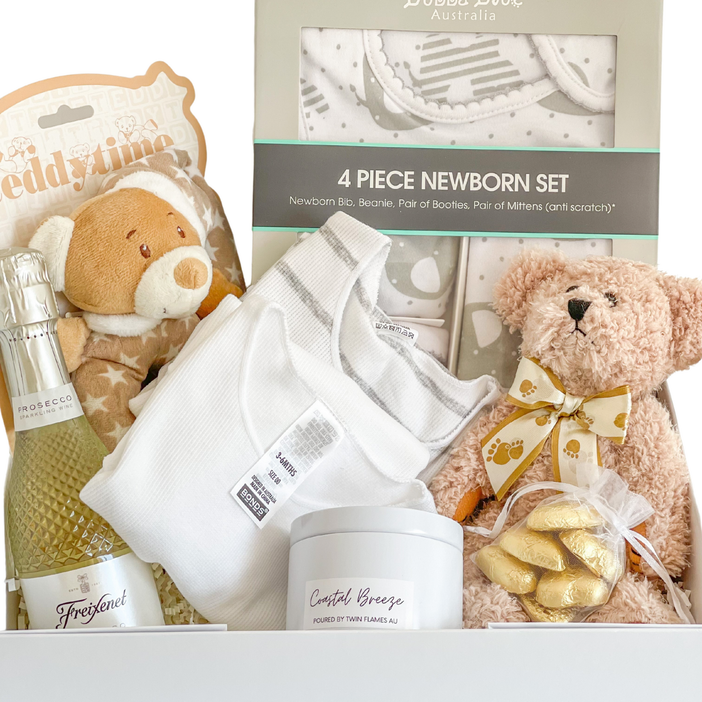 Congratulations Mum and Baby Gift Box  Included in this gift box:   Bubba Blue 4 Piece Newborn Set   Bonds Short Sleeve body suit Size 3-6 months (size 00)   Teddy Bear ring rattle (16cm)   Light brown teddy bear soft toy (20cm)   Soy candle tin by Twin Flames (Very Vanilla, French pear or coastal breeze randomly selected)   6 x Belgian chocolate hearts in gold   Presented in a white keepsake gift box and our signature blue satin ribbon 