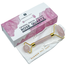 Load image into Gallery viewer, A gorgeous Rose Quartz facial roller packaged in a luxe gift box with satin lining. Includes instructions on how to use and a draw string pouch for protecting the roller and easy transport.  This deluxe facial roller will help promote:  Increase blood flow and detoxification Reduces face inflammation and puffiness Makes your skin glow naturally Tightens the skin Softens the complexion Promotes lymphatic drainage

