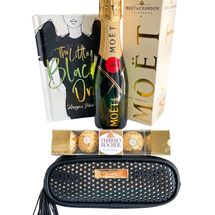 Moet & Chandon piccolo 200mL with gift box  The Little Black Dress book by Megan Hess. A fantastic little book to celebrate the designers, women and dresses MOR Black case is the perfect travel accessory, ideal for your handbag. Keep all beauty essentials on the go. Features luxury splash proof fabric and tasselled zip enclosure. Measures 19.5cm length, 5cm width and 7.5cm height Ferrero Rocher chocolate gift box (5 pack) 